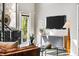 Modern living room with a wall-mounted TV, sleek storage cabinets, and a view of lush greenery outside at 307 Cherokee Se Ave # 9, Atlanta, GA 30312