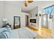 Stylish bedroom with modern fireplace, hardwood floors, natural light, and decor with view of ensuite at 307 Cherokee Se Ave # 9, Atlanta, GA 30312