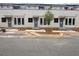 Three story townhome with gray doors, lots of windows and tan brick facade at 003 White St # 3, Marietta, GA 30060