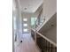 Bright hallway featuring hardwood floors, white trim, and modern staircase with metal balusters at 003 White St # 3, Marietta, GA 30060