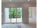 Living room with sliding glass doors to deck; adjacent to a dining area with decorative chandelier at 003 White St # 3, Marietta, GA 30060
