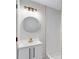 Bathroom features modern lighting, stylish vanity, mirror, and subway tile shower with gold accents at 2254 Glendale Drive, Decatur, GA 30032