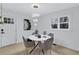 Well-lit dining room with a modern light fixture and marble table set for four at 2254 Glendale Drive, Decatur, GA 30032