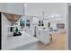 Modern white kitchen with stainless steel appliances and island that opens into living space at 2254 Glendale Drive, Decatur, GA 30032