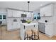 Modern kitchen featuring white cabinets, stainless steel appliances, and island seating at 2254 Glendale Drive, Decatur, GA 30032