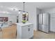 Modern white kitchen with stainless appliances and island with seating adjacent living room at 2254 Glendale Drive, Decatur, GA 30032