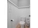 Charming powder room features wainscoting, adding a touch of elegance to this functional space at 1326 Harlequin Way, Stockbridge, GA 30281