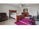 A well lit bedroom with wood furniture and a large area rug at 1326 Harlequin Way, Stockbridge, GA 30281