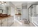 Bright bathroom with dual vanity, granite countertops, tiled floors, and a glass-enclosed shower at 1459 Hedgewood Nw Ln, Kennesaw, GA 30152