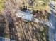 Overhead shot of a home with metal roof, driveway, and spacious yard near a road, captured on a sunny day at 17 Cross Creek Pkwy, Dallas, GA 30157