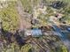 Aerial view of a wooded property featuring a house with a metal roof and a front porch near a street at 17 Cross Creek Pkwy, Dallas, GA 30157