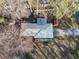 Aerial view of home with metal roof, mature trees, and a long driveway on a sunny day at 17 Cross Creek Pkwy, Dallas, GA 30157