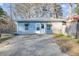 Charming blue house with a concrete driveway and a small deck creating a cozy exterior at 17 Cross Creek Pkwy, Dallas, GA 30157