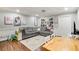 Cozy finished basement with gray sectional, built-in shelves, and laminate wood flooring at 17 Cross Creek Pkwy, Dallas, GA 30157