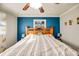 Bedroom with blue accent wall behind a large bed with ceiling fan and wood floors at 17 Cross Creek Pkwy, Dallas, GA 30157