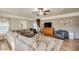 Open living room with a brick accent wall, plush sectional couch, and natural light at 17 Cross Creek Pkwy, Dallas, GA 30157