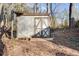 Rustic storage shed with double doors providing practical storage solutions in the backyard at 17 Cross Creek Pkwy, Dallas, GA 30157