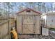 Wooden storage shed with a red roof providing extra space for tools and equipment at 17 Cross Creek Pkwy, Dallas, GA 30157