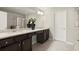 Bathroom with dual sinks and dark wood cabinetry offers plenty of counter space at 2628 Wild Laurel Ct, Norcross, GA 30071