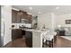 Modern kitchen featuring dark wood cabinets, stainless steel appliances, granite countertops, and an island with seating at 2628 Wild Laurel Ct, Norcross, GA 30071