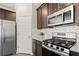 Close up on the kitchen with stainless steel appliances, white subway tile and dark wood cabinets at 2628 Wild Laurel Ct, Norcross, GA 30071