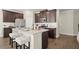 Beautiful kitchen with stainless steel appliances, granite countertop island with seating, and dark wood cabinets at 2628 Wild Laurel Ct, Norcross, GA 30071