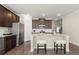 Beautiful kitchen with stainless steel appliances, granite countertop island with seating, and dark wood cabinets at 2628 Wild Laurel Ct, Norcross, GA 30071