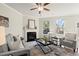 Bright living room features a fireplace, two windows and modern furnishings at 2628 Wild Laurel Ct, Norcross, GA 30071