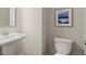 Small powder room with a pedestal sink and modern fixtures at 2628 Wild Laurel Ct, Norcross, GA 30071