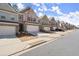 Street view showcases a row of charming townhomes with individual driveways at 2628 Wild Laurel Ct, Norcross, GA 30071