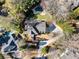 Overhead view of a property with an in-ground pool, stone patio, lush landscaping, and winding driveway at 4399 Jett Nw Pl, Atlanta, GA 30327