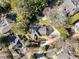 Aerial view of a home with a backyard pool, outdoor kitchen, and landscaping, nestled among mature trees at 4399 Jett Nw Pl, Atlanta, GA 30327