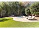 Tranquil backyard pool area featuring lounge chairs, bamboo backdrop, and a serene retreat setting at 4399 Jett Nw Pl, Atlanta, GA 30327