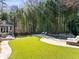 Lush backyard with a stone walkway, inviting pool, and cozy outdoor seating, surrounded by tall bamboo at 4399 Jett Nw Pl, Atlanta, GA 30327