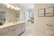 Bright bathroom featuring a double vanity, white cabinets, and a window for natural light at 4399 Jett Nw Pl, Atlanta, GA 30327