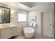 Modern bathroom with soaking tub, stone floors, and white vanity at 4399 Jett Nw Pl, Atlanta, GA 30327