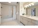 Clean white bathroom featuring white tiled floors and a shower/tub combination at 4399 Jett Nw Pl, Atlanta, GA 30327