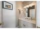 Powder room with a white vanity, a framed mirror, and decorative wall art at 4399 Jett Nw Pl, Atlanta, GA 30327