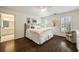 Bright bedroom featuring hardwood floors, a ceiling fan, and a comfortable armchair near the window at 4399 Jett Nw Pl, Atlanta, GA 30327