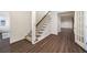 Hallway featuring hardwood floors, stairs with carpet, and a glass paneled door at 4399 Jett Nw Pl, Atlanta, GA 30327