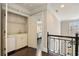 Hallway with wet bar, mini fridge, and iron banister at 4399 Jett Nw Pl, Atlanta, GA 30327