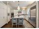 Beautiful kitchen featuring stainless steel appliances, an eat-in island, and white cabinets throughout at 4399 Jett Nw Pl, Atlanta, GA 30327