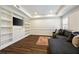 Inviting living room featuring built-in shelving, TV, and comfortable gray sectional sofa at 4399 Jett Nw Pl, Atlanta, GA 30327