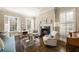 Bright living room featuring hardwood floors, plantation shutters, and a cozy fireplace at 4399 Jett Nw Pl, Atlanta, GA 30327