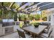 Outdoor dining area with pergola, grill, and seating, ideal for entertaining at 4399 Jett Nw Pl, Atlanta, GA 30327