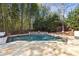 Relaxing pool featuring a small waterfall and stone surround, set against a tranquil backdrop of bamboo at 4399 Jett Nw Pl, Atlanta, GA 30327