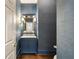 Stylish powder room with a blue vanity, and unique blue textured wallpaper at 4399 Jett Nw Pl, Atlanta, GA 30327