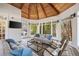 Light-filled sunroom with wood details, ample seating, and views of the lush backyard at 4399 Jett Nw Pl, Atlanta, GA 30327