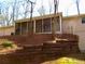 Backyard showing retaining wall and screened in porch on the back of the house at 901 Guys Sw Ct, Lilburn, GA 30047