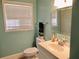 Bright bathroom features a neutral color palette and a modern single sink vanity at 901 Guys Sw Ct, Lilburn, GA 30047